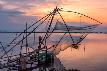 Woman fishing on sunset. An Giang province, Vietnam.