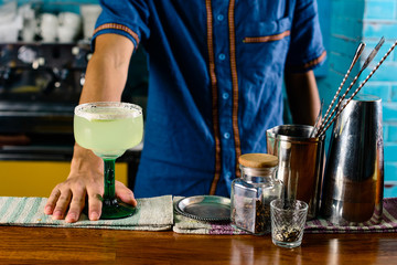 Bartender finished decorating his cocktail in bar