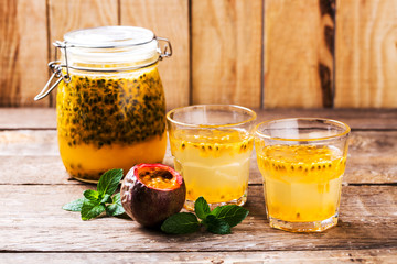 Passion fruit drinks. Homemade passion fruit in a glass jar and glasses