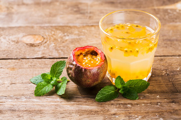Glass of fresh passion fruit with mint on table