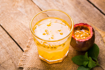 Glass of fresh passion fruit with mint on table