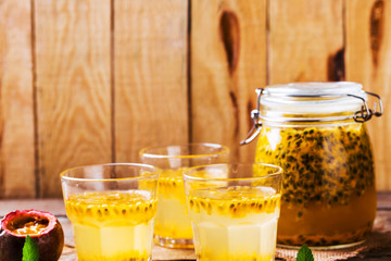Passion fruit drinks. Homemade passion fruit in a glass jar and glasses