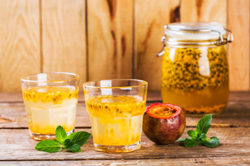 Passion fruit drinks. Homemade passion fruit in a glass jar and glasses