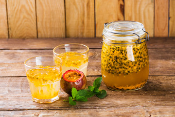 Passion fruit drinks. Homemade passion fruit in a glass jar and glasses