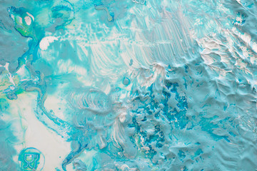 Thick dense layers of blue, white and turquoise paint