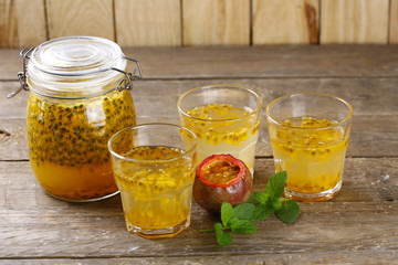 Passion fruit drinks. Homemade passion fruit in a glass jar and glasses