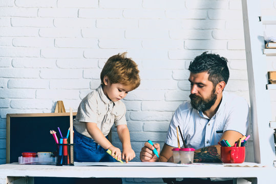 Preparing for school. Child goes to school soon. Hello September. Pre-school education, the preschooler draws with father. Development. Creative education. Drawing family, father looks how son draws - Powered by Adobe