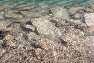 Barcis, Pordenone, Italy stones in the clear water of a lake.