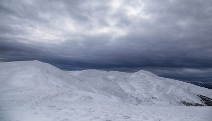 Gray sky and snow mountains
