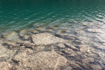 Barcis, Pordenone, Italy stones in the clear water of a lake.