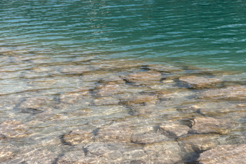 Barcis, Pordenone, Italy stones in the clear water of a lake.