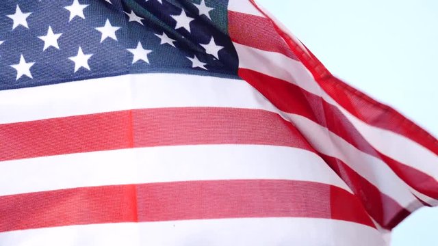 Close up of USA united states of america flag waving on wind. National landmark concept