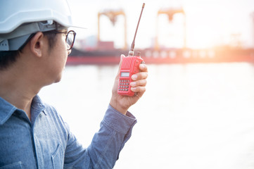Asian engineers are checking their work with radio communications.