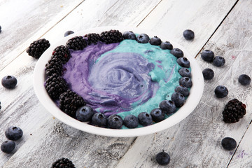 Healthy breakfast. smoothie bowl with blackberries and granola on rustic background