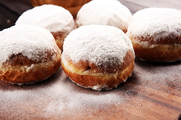 German donuts with jam and icing sugar. Carnival powdered sugar raised donuts