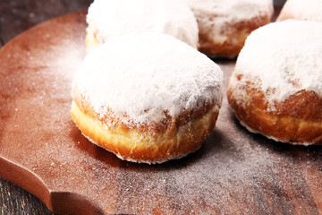 German donuts with jam and icing sugar. Carnival powdered sugar raised donuts