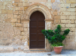 Fototapeta na wymiar Brown wooden door of old house in Mdina, Malta