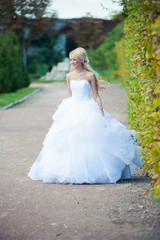 Beautiful blonde bride in fashion white wedding dress