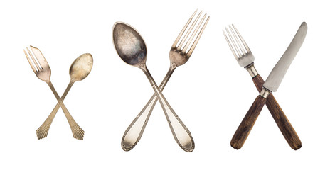 3 set crossed vintage spoon and fork isolated on old vintage background. Rustic style