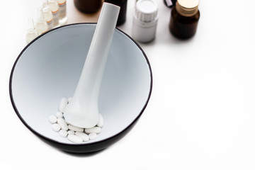 Mortar and pestle with pills and pill bottles 