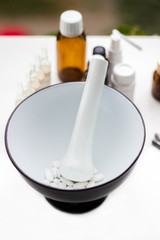 Mortar and pestle with pills and pill bottles 