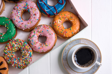 Colorful Donuts with Coffee in White Backdrop