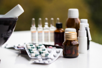 Mortar and pestle with pills and pill bottles 