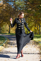 Young beautiful blonde woman in long black dress