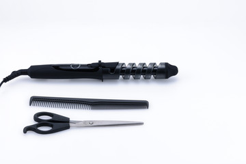 Grey hair iron with accessory on the white background with copy space.