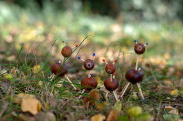 Group of funny chestnut animals in green grass, traditional autumn handcraft, European roe deer with family