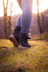 Boots of a young woman, cutout, outdoors in timberland, autumn