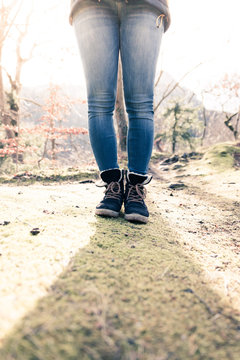 Boots of a young woman, cutout, outdoors in timberland, autumn