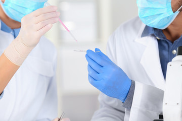Scientists working in laboratory, closeup view. Research and analysis