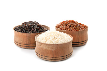 Bowls with different types of rice on white background