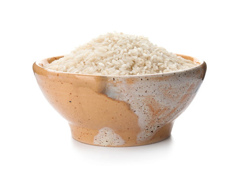 Bowl with uncooked rice on white background