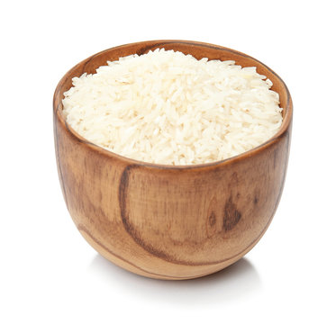 Bowl with uncooked rice on white background