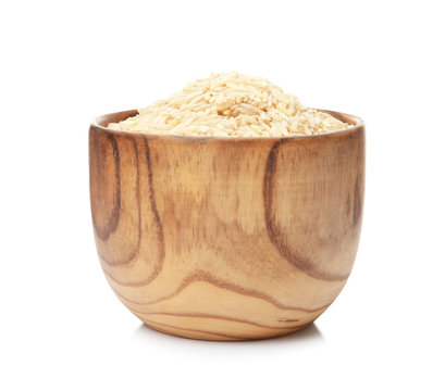 Bowl with raw unpolished rice on white background