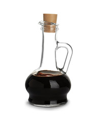 Glass jug with balsamic vinegar on white background