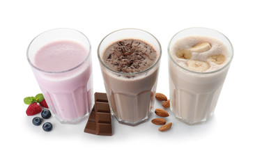 Glasses with different protein shakes and ingredients isolated on white