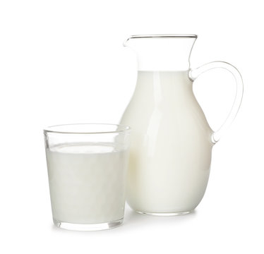 Glass and jug with fresh milk on white background