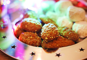 traditional greek melomakarona and kourabies on the table - Christmas cookies with honey and nuts and sugar buns