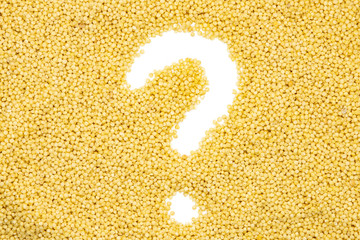 Millet groats, question mark, close up, top view. Gluten-Free and non-allergenic grain use in...