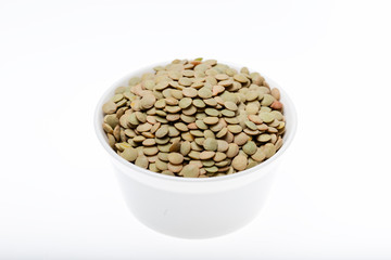 Bowl of green lentil on white background