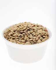 Bowl of green lentils on white background 