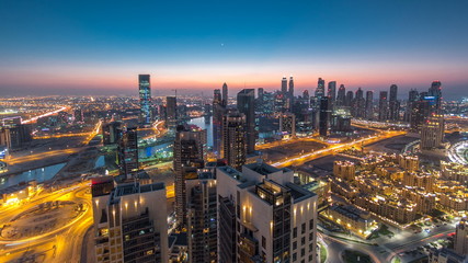 Scenic aerial view of a big modern city day to night timelapse. Business bay, Dubai, United Arab Emirates.