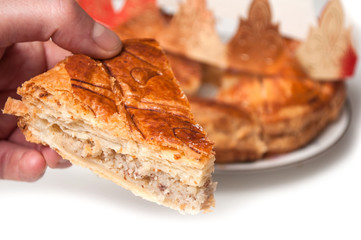 closeup of epiphany cake with golden crown on white background 
