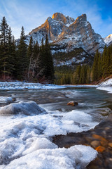 Mount Kidd, a mountain in Kananaskis in the Canadian Rocky Mountains, Alberta, Canada and the Kananaskis River in winter
