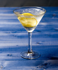 Detox after party. Health care concept. What to drink on party. Glass with water slice of lemon on blue table. Reduce alcohol harmful influence. Detox drink to feel better. Hangover and detox