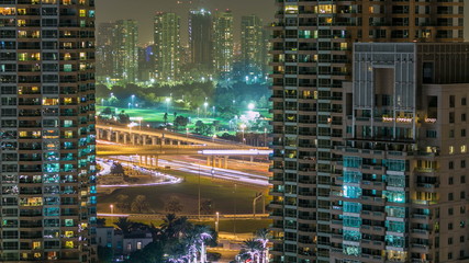 Golf field timelapse from top at night time with traffic on sheikh zayed road.