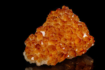 Macro mineral stone Citrine in rock in crystals on a black background